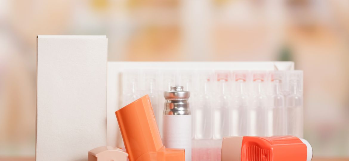 Two portable inhaler with dispenser and a box of ampoules on table